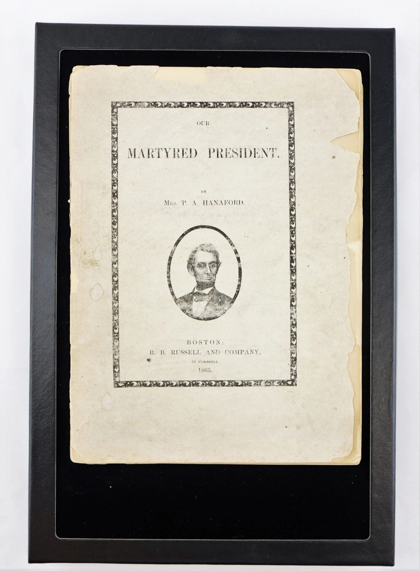 Framed 1865 "Our Martyred President" by Phoebe Anne Hanaford, featuring a black and white Abraham Lincoln illustration on the cover.