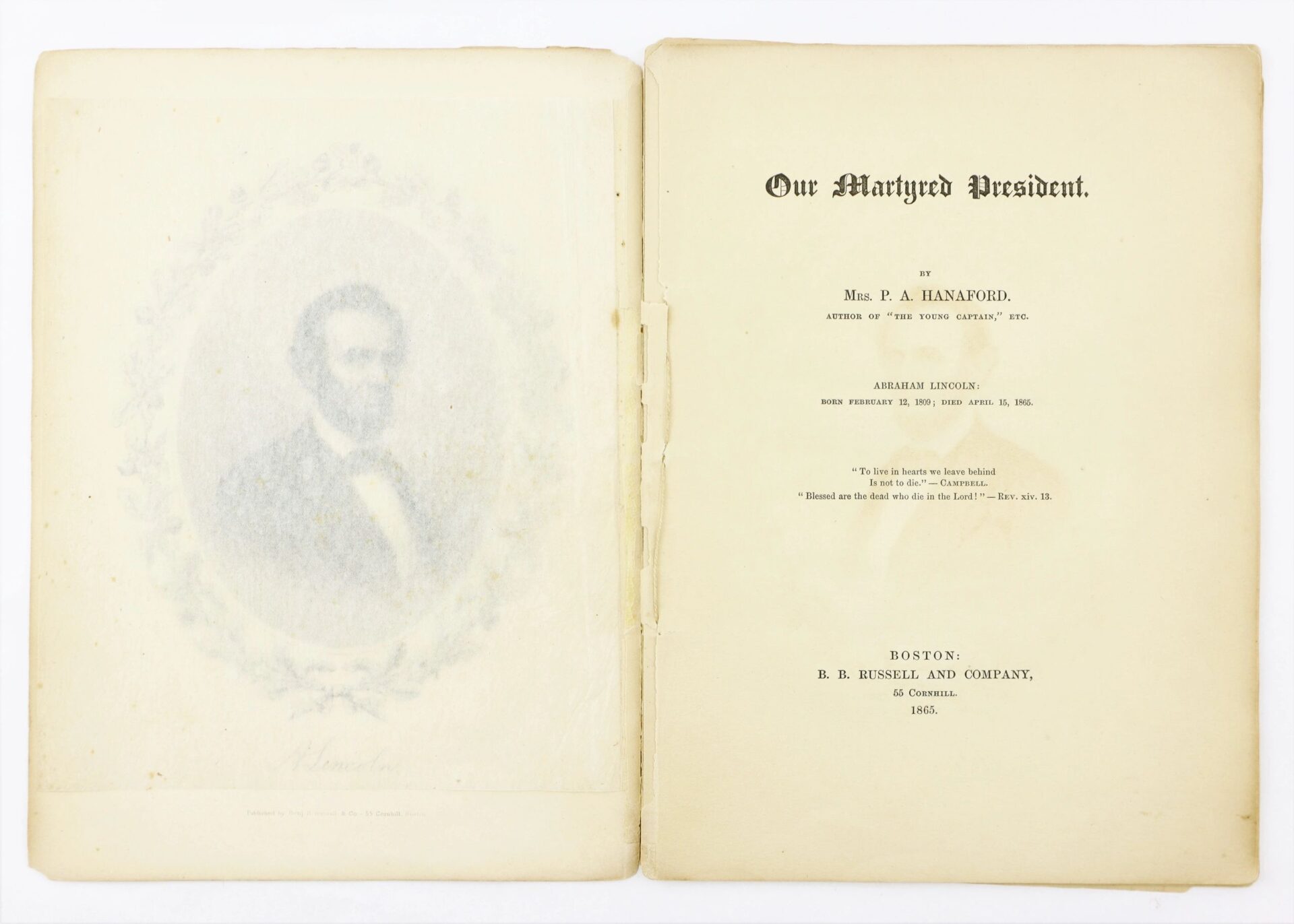 Open book displays a faded Lincoln portrait beside the title page of "1865 Our Martyred President" by Phoebe Anne Hanaford, now SOLD.
