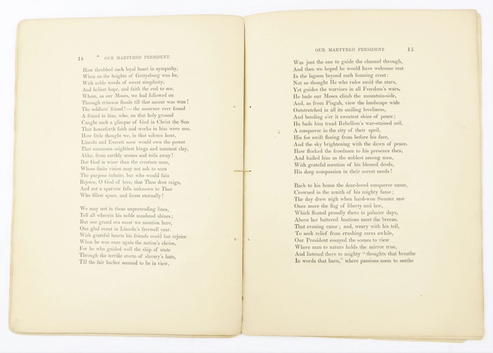 An open book displays pages 14 and 15 of "1865 Our Martyred President by Phoebe Anne Hanaford" in black serif font on cream-colored paper.