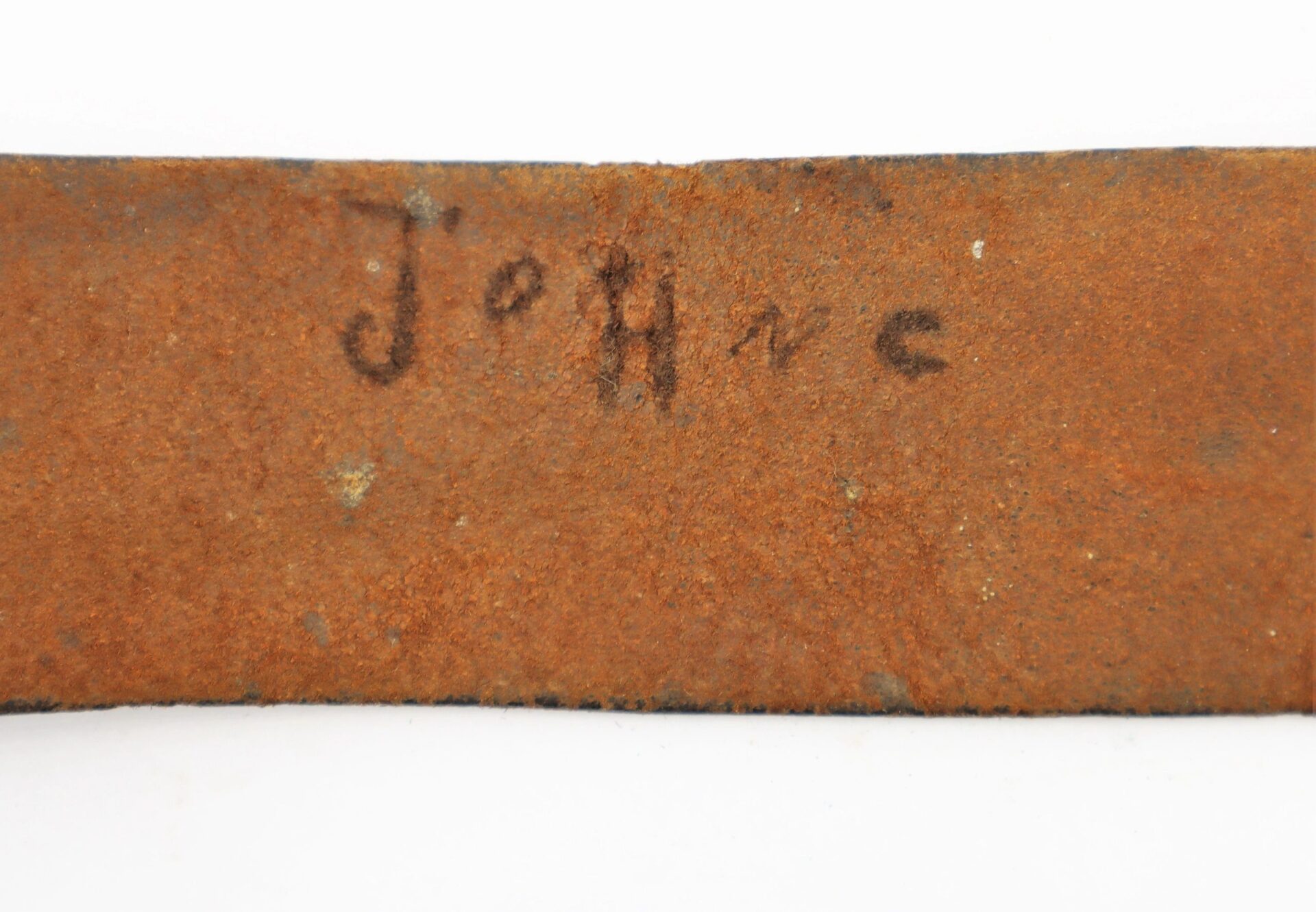 A close-up of a rusty metal surface features "Enlisted Infantryman's Belt Equipped with Model 1839 'US' Belt Plate and Cap Pouch / SOLD" handwritten in faded black marker.