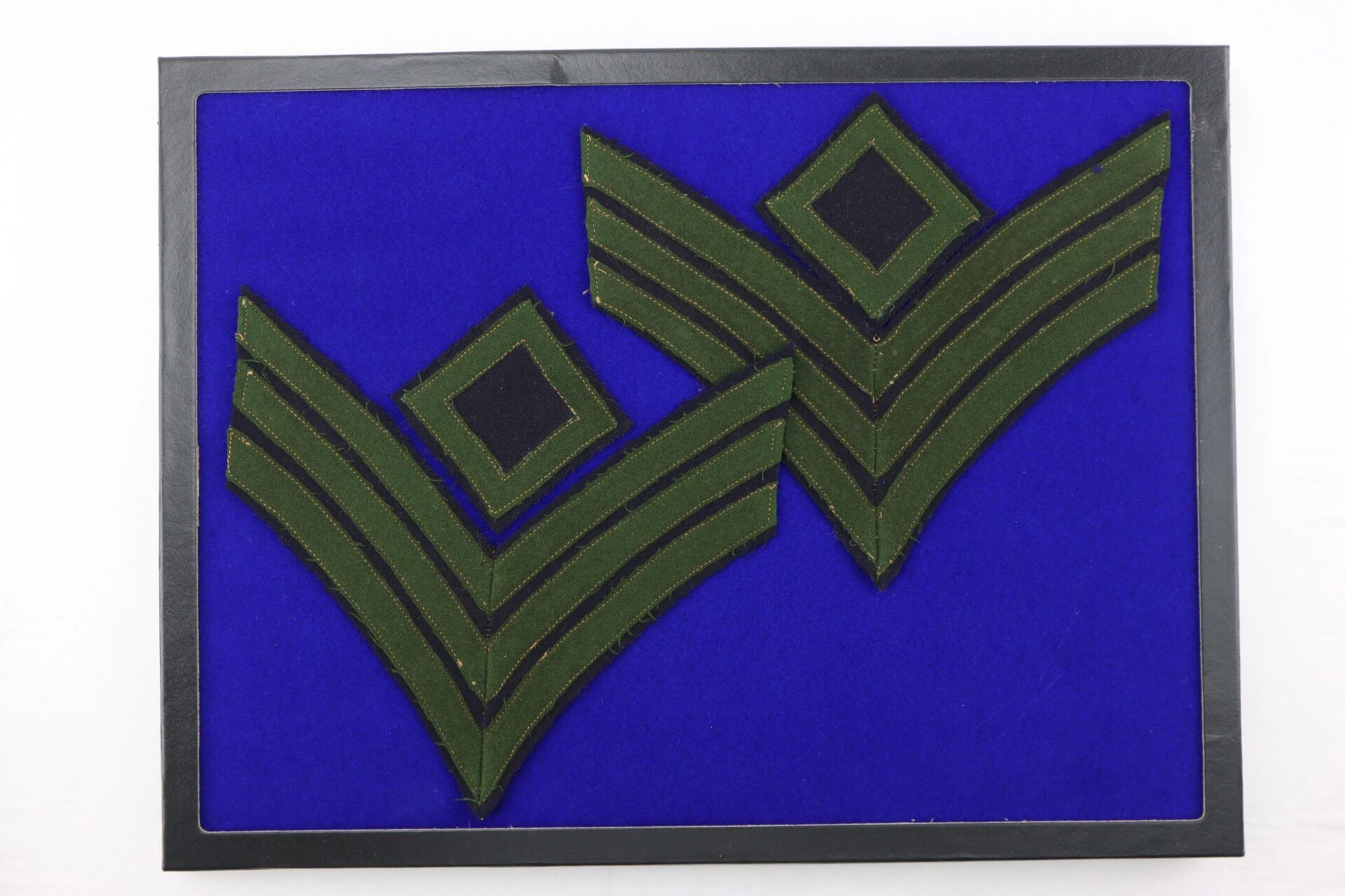A pair of Civil War Rifleman/Sharpshooter chevrons featuring dark green diamond-shaped insignia on a blue rectangular background.