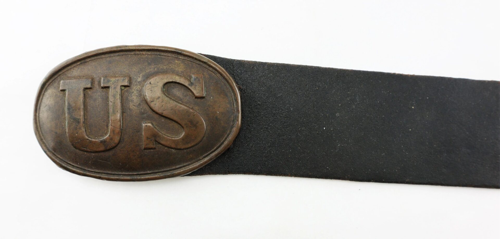 A U.S. Enlistedman’s black leather belt with an oval brass "US" buckle, marked “A.B. Covell.” / SOLD.