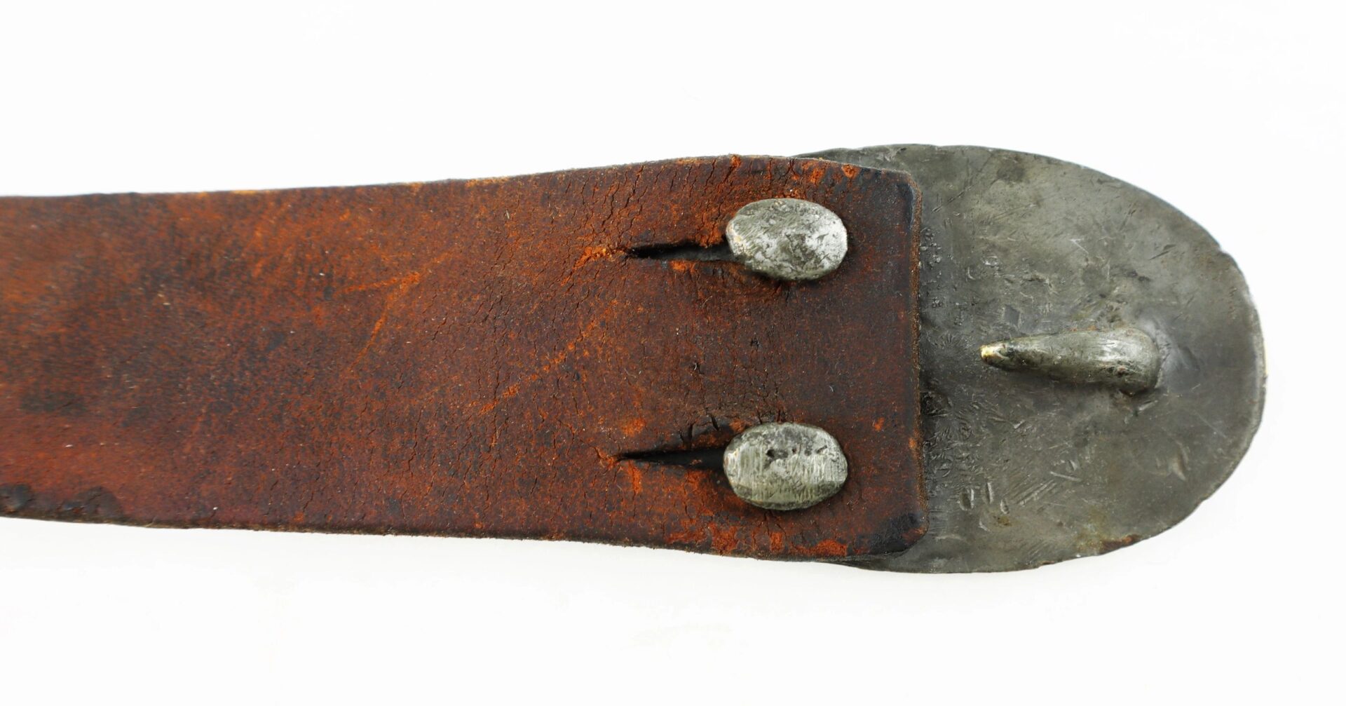 Close-up of a worn brown leather U.S. Enlistedman’s Belt marked “A.B. Covell,” featuring a metal plate and two round rivets at one end. / SOLD.