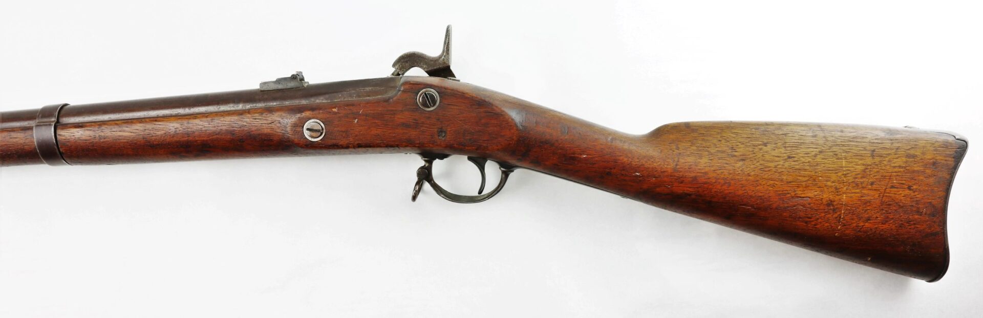 Side view of a Confederate “Captured and Collected” Model 1861 Springfield Rifle-Musket, featuring a wooden stock, metal barrel, and hammer mechanism, displayed on a white background.