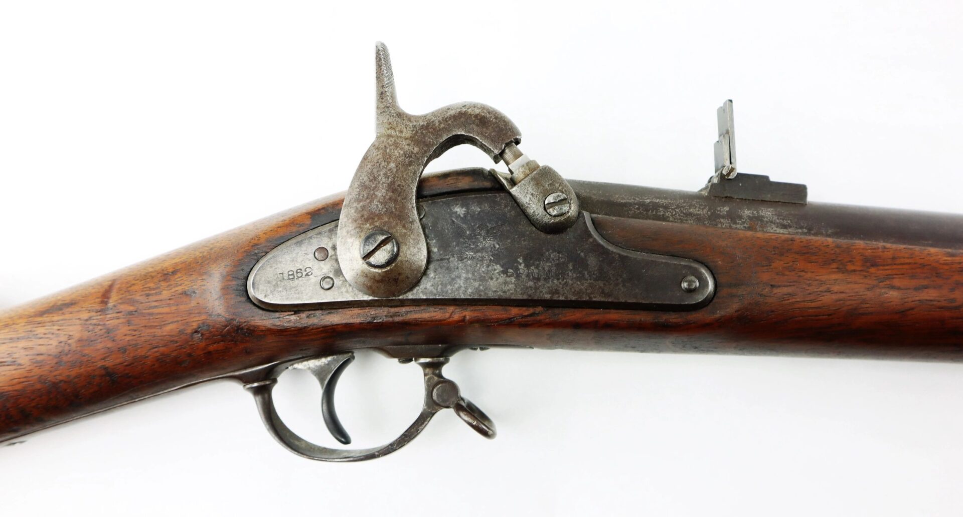 Close-up of a Confederate “Captured and Collected” Model 1861 Springfield Rifle-Musket lock mechanism, highlighting the wooden stock, metal trigger, hammer, and visible wear and patina.