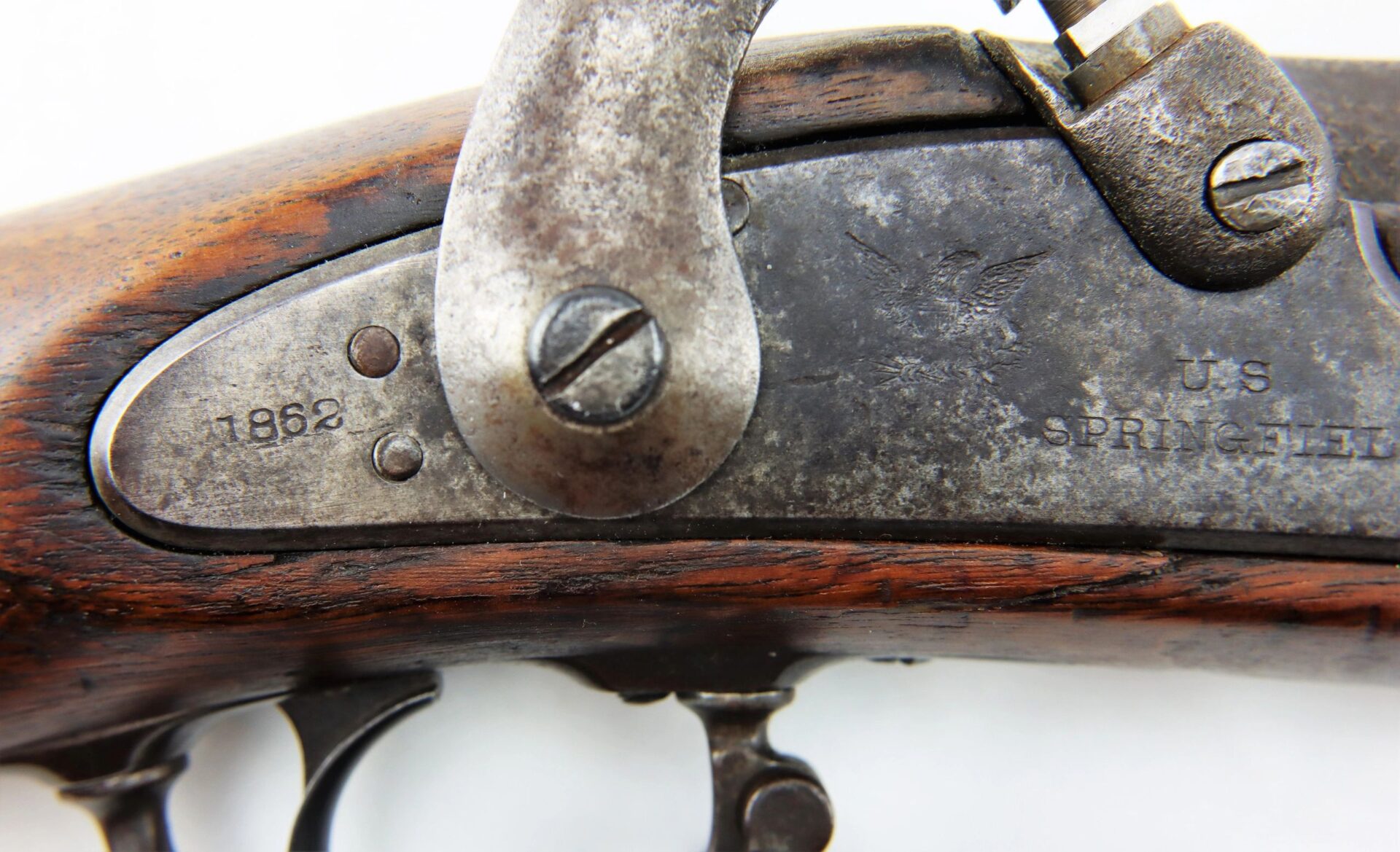 Close-up of the lock plate on a Confederate "Captured and Collected" Model 1861 Springfield Rifle-Musket, showing the year 1862, an eagle emblem, and markings "U.S. SPRINGFIELD.