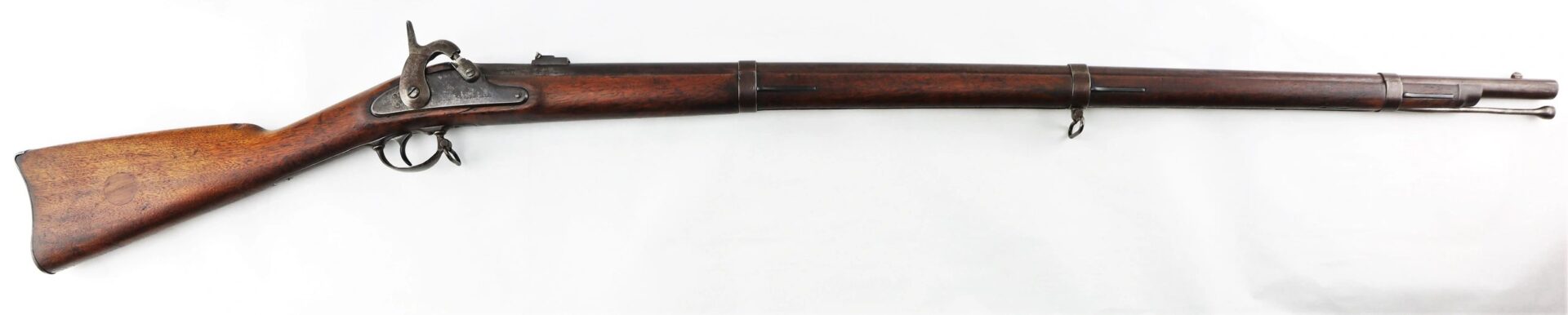 The Confederate “Captured and Collected” Model 1861 Springfield Rifle-Musket features a wooden stock, metal barrel, iron sights, three barrel bands, and a percussion lock mechanism.