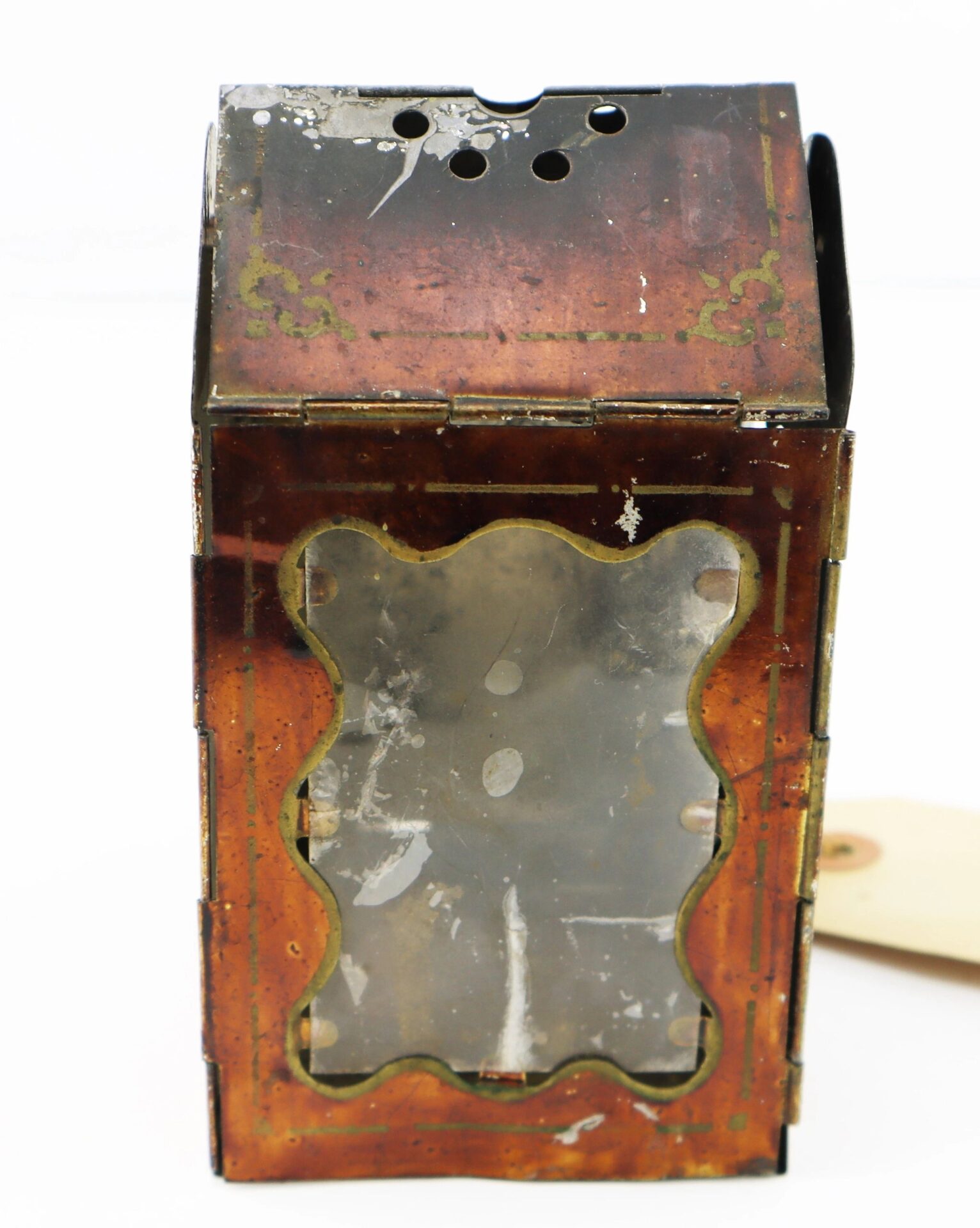 The Civil War Era Minor’s Patent Lantern features a vintage, rusted metal design with a decorative glass front panel, perforated top, and visible wear and discoloration.