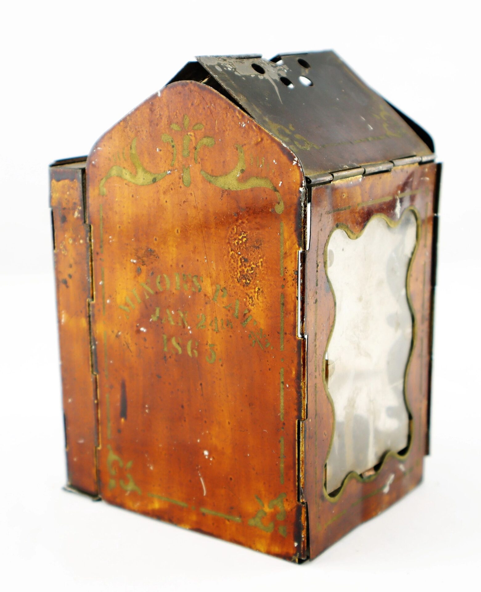 Civil War Era Minor’s Patent Lantern featuring antique metal, glass pane, faded writing, decorative designs, hinged top, and visible signs of age and wear.