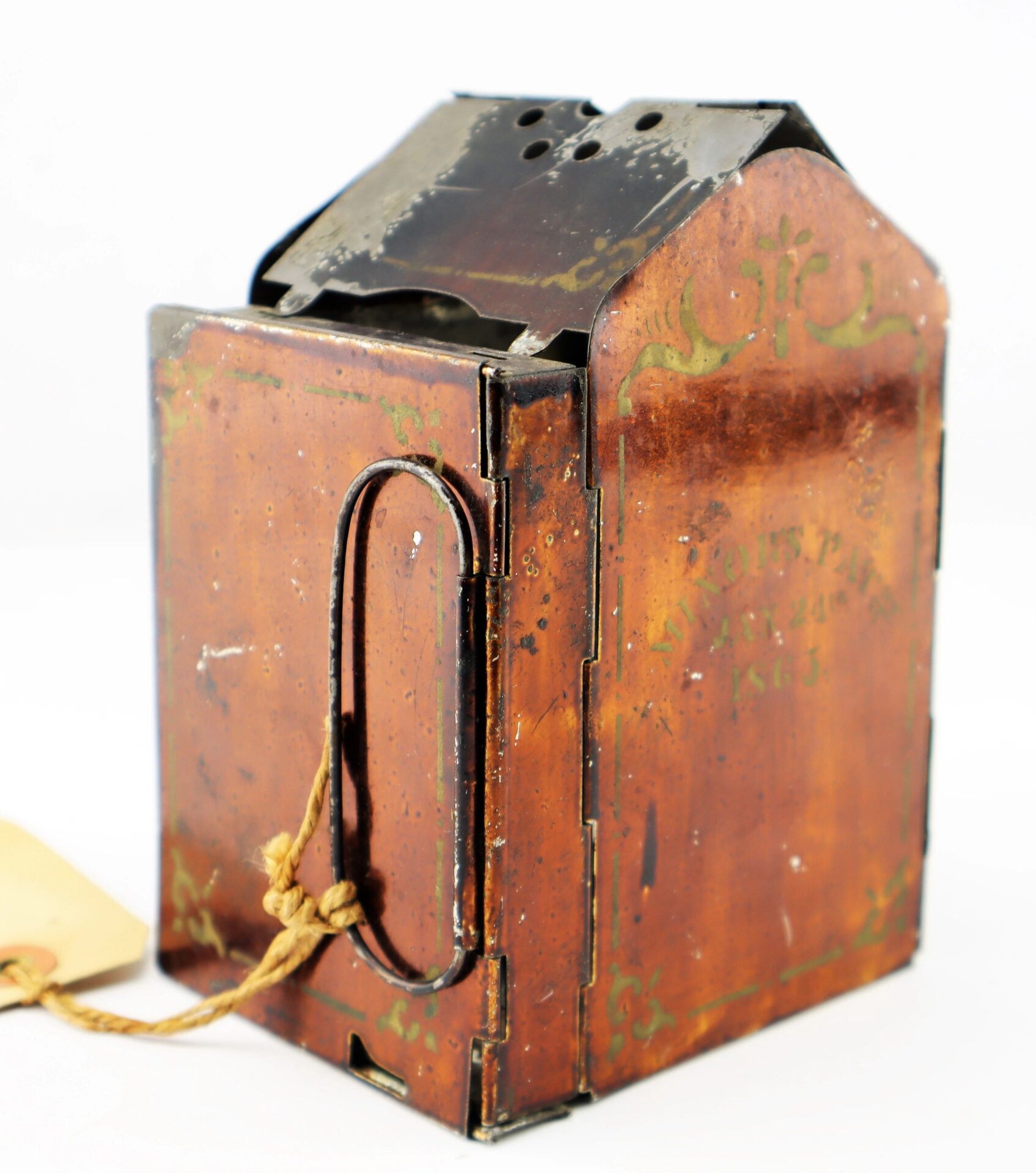 The Civil War Era Minor’s Patent Lantern features vintage metal and wood, a hinged top, side handle, ventilation holes, and a string-attached tag.