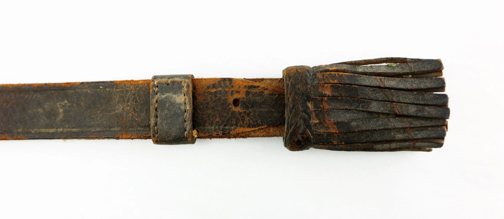 A Civil War Cavalry Enlisted Saber Knot with a worn leather strap, loop, and frayed end is displayed against a white background.