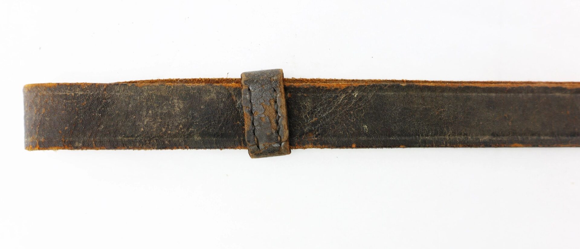 A Civil War Cavalry Enlisted Saber Knot, showing signs of wear with visible cracks, is displayed flat on a white background.