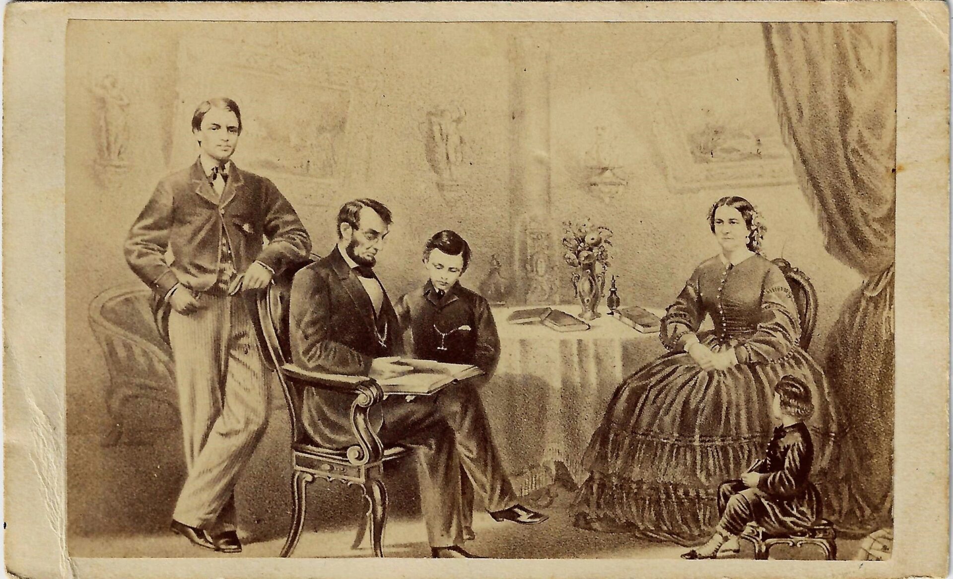 CDV of Abraham Lincoln and Family / SOLD: Sepia-toned photograph showing Abraham Lincoln seated with his wife and two sons, one boy standing beside Mrs. Lincoln. The family is indoors, arranged around a table with a vase of flowers.