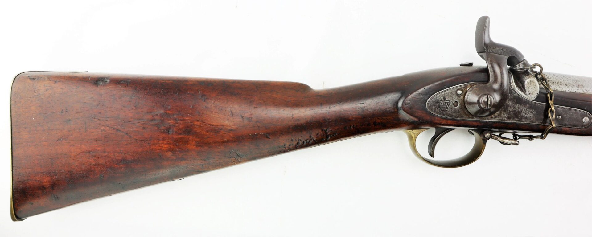 Side view of a Commercial Enfield Rifle featuring a wooden stock, metal trigger guard, and hammer mechanism against a white background.
