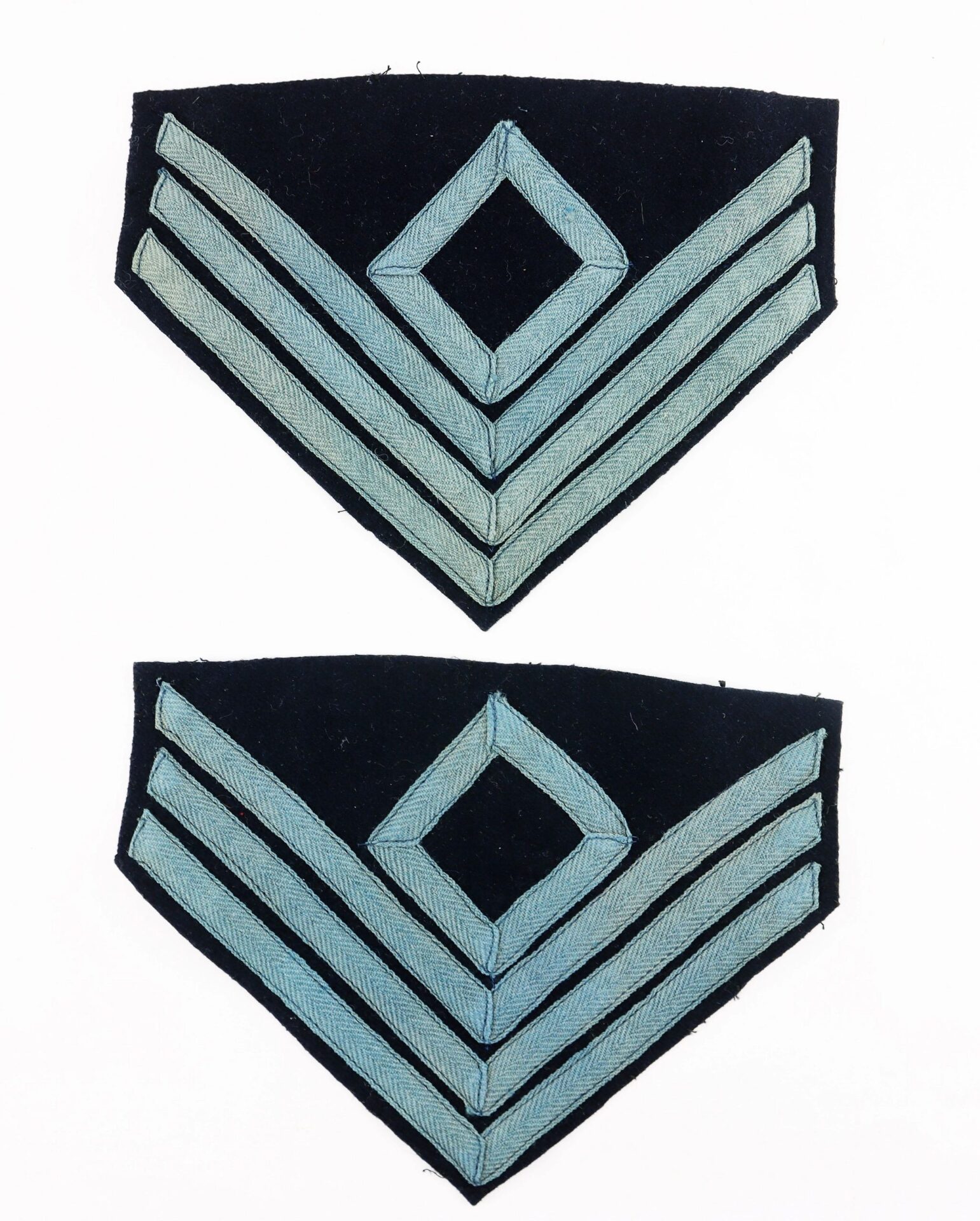 Pair of First Sergeant of Infantry Chevrons—each features three light blue stripes with a diamond above, set against a dark background.
