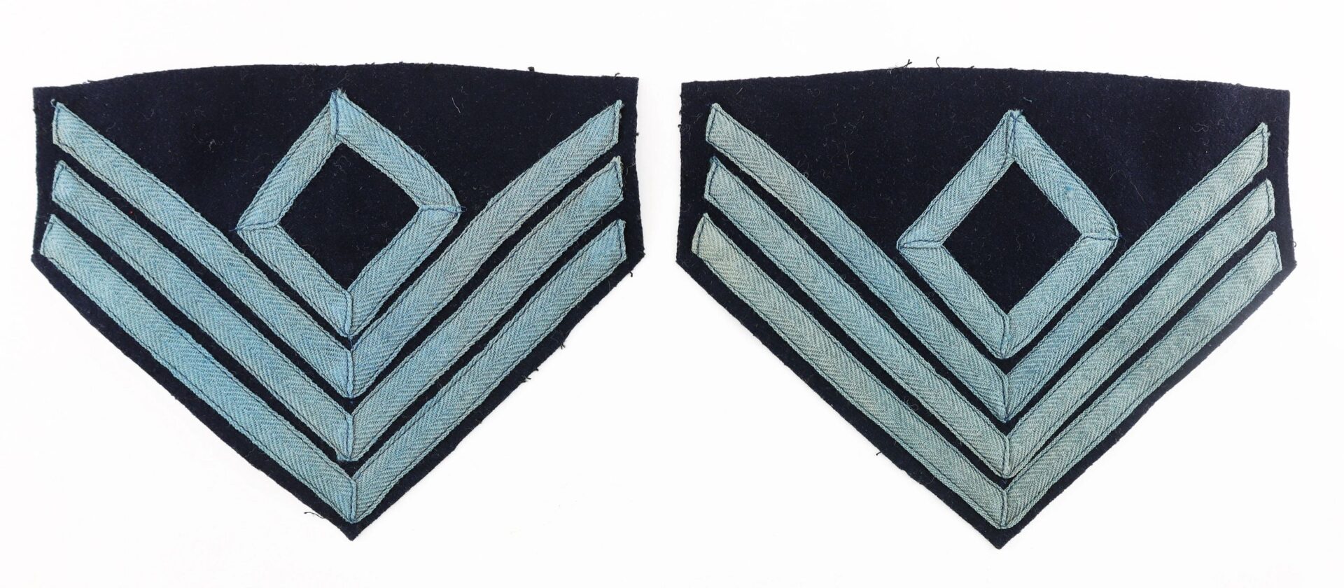Two identical First Sergeant of Infantry Chevron patches, each featuring three light blue chevrons and a central diamond on a dark background.