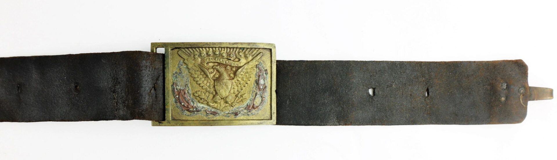 A worn U.S. Foot Artillery Belt in black leather with a square brass buckle, embossed eagle, and decorative motifs.