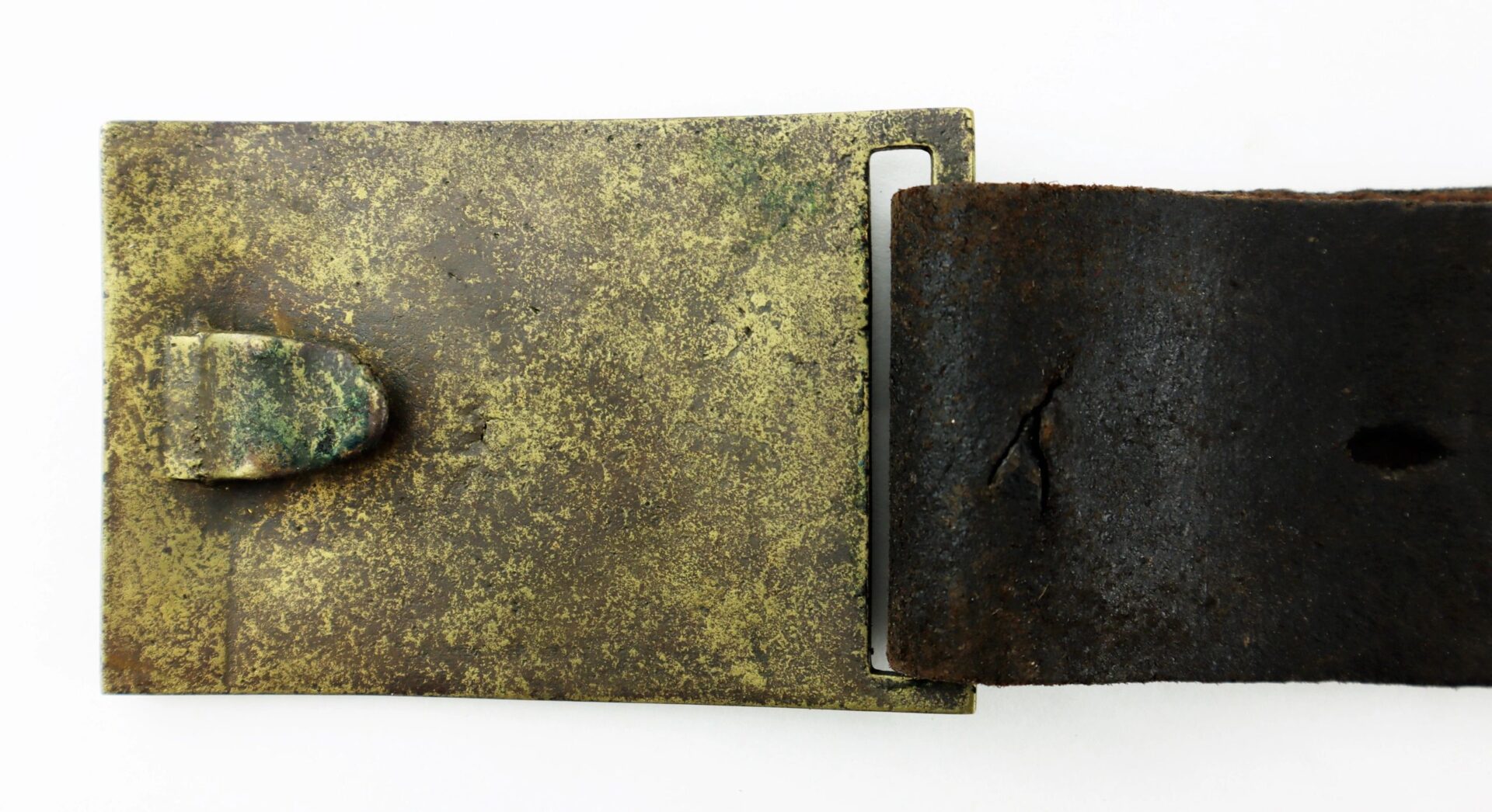 A close-up of the U.S. Foot Artillery Belt's tarnished metal buckle on a worn, cracked leather strap, set against a white background.