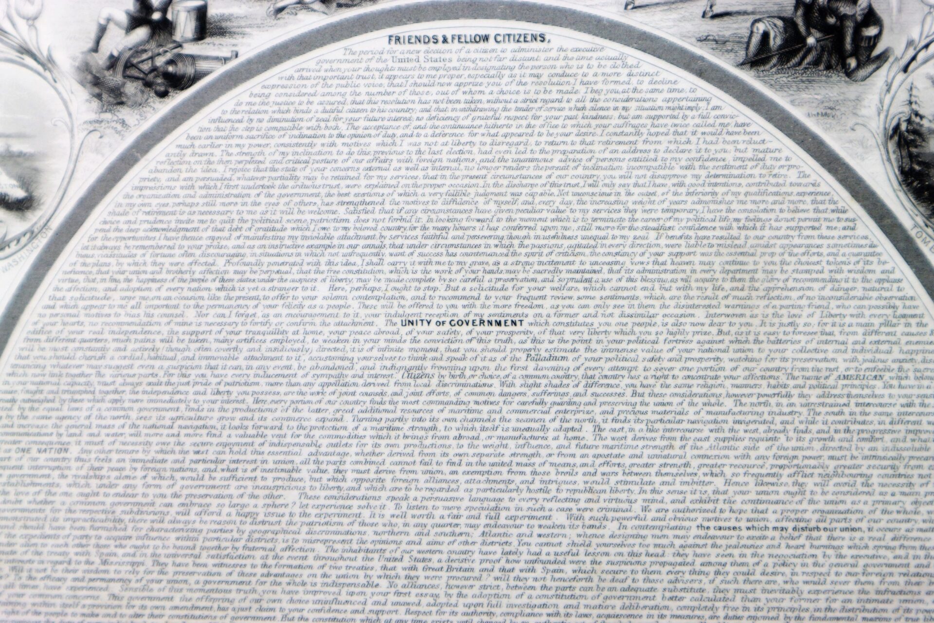 Close-up of Washington’s Farewell, a historical document with densely packed printed text; the headings "Friends & Fellow Citizens" and "Unity of Government" are clearly visible in the center.