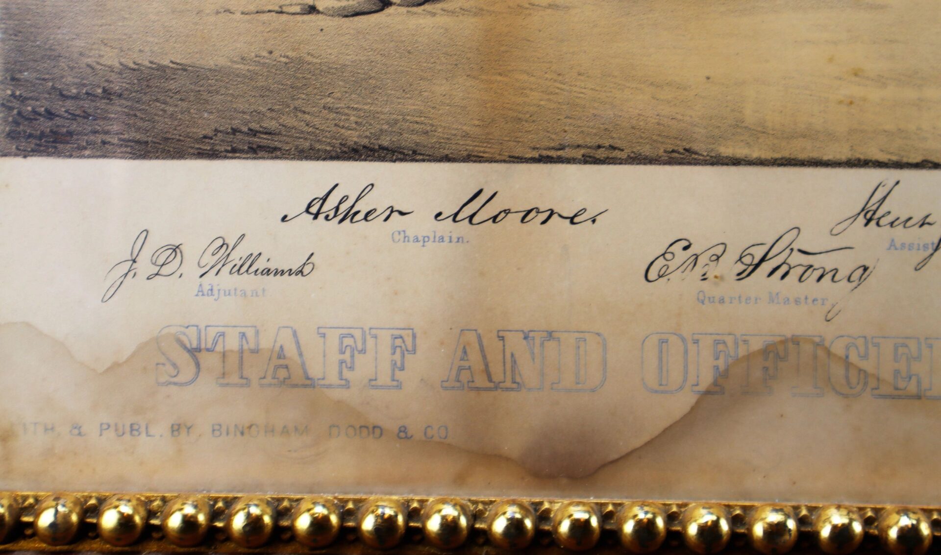 A detailed view of the very rare and colorful 1861 print, “Officers and Staff of the Putnam Phalanx as Originally Constituted in Front of the Old State House in Hartford.” Handwritten names appear beneath decorative gold borders.