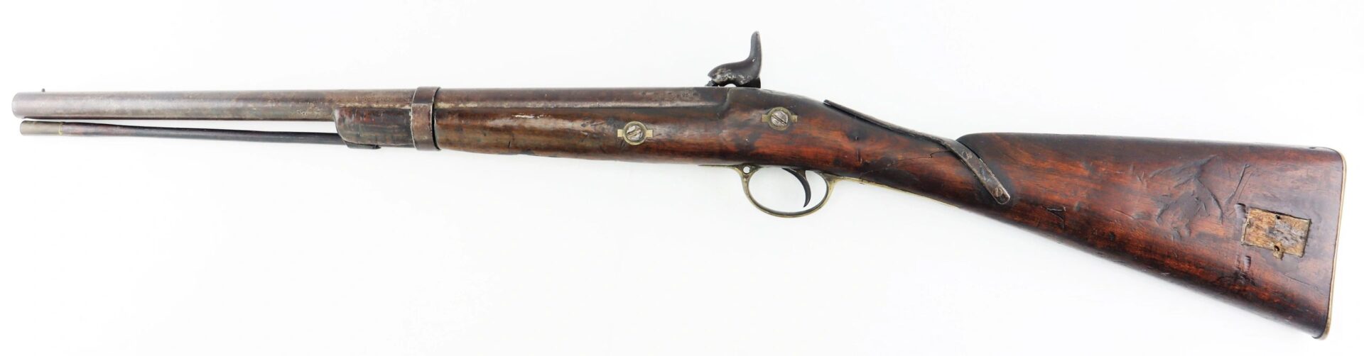 A Confederate 1863-dated Enfield rifle, altered to a cavalry carbine, featuring a wooden stock, metal barrel, and visible signs of age and use on both wood and metal.