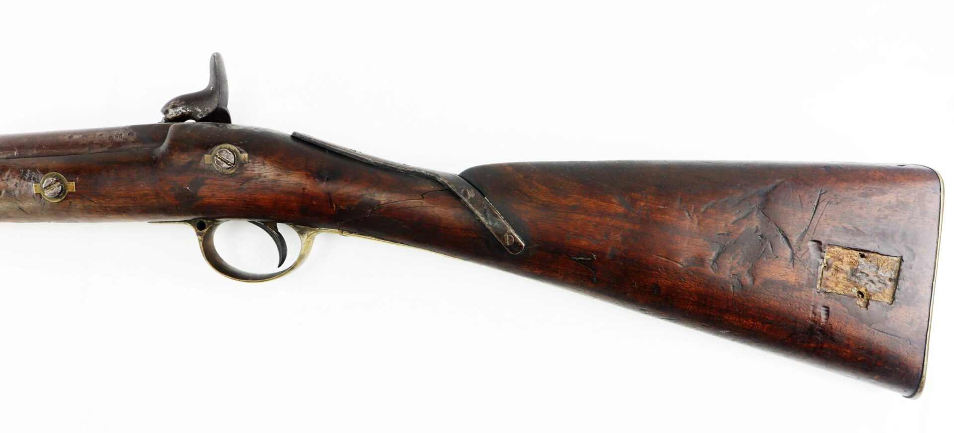Side view of the worn wooden stock and trigger of a Confederate 1863 Dated Enfield Altered to a Cavalry Carbine, shown against a white background.