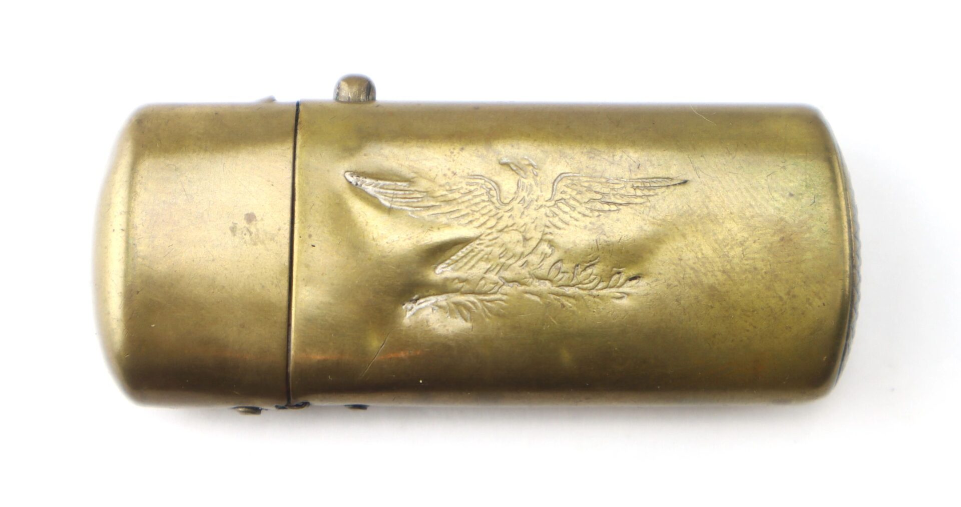 Civil War Era Patriotic Match Safe—oval-shaped brass with hinged lid, embossed eagle holding arrows and olive branch.