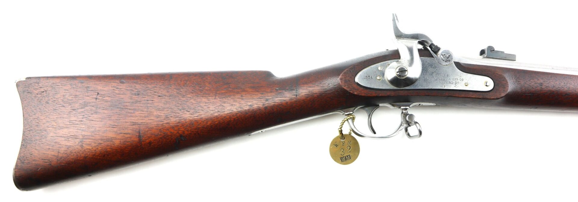 Side view of a U.S. Model 1861 Special Colt Contract Rifle Musket (dated 1864/SLD) showing wooden stock, lock mechanism, trigger, and metal tag attached to the trigger guard.