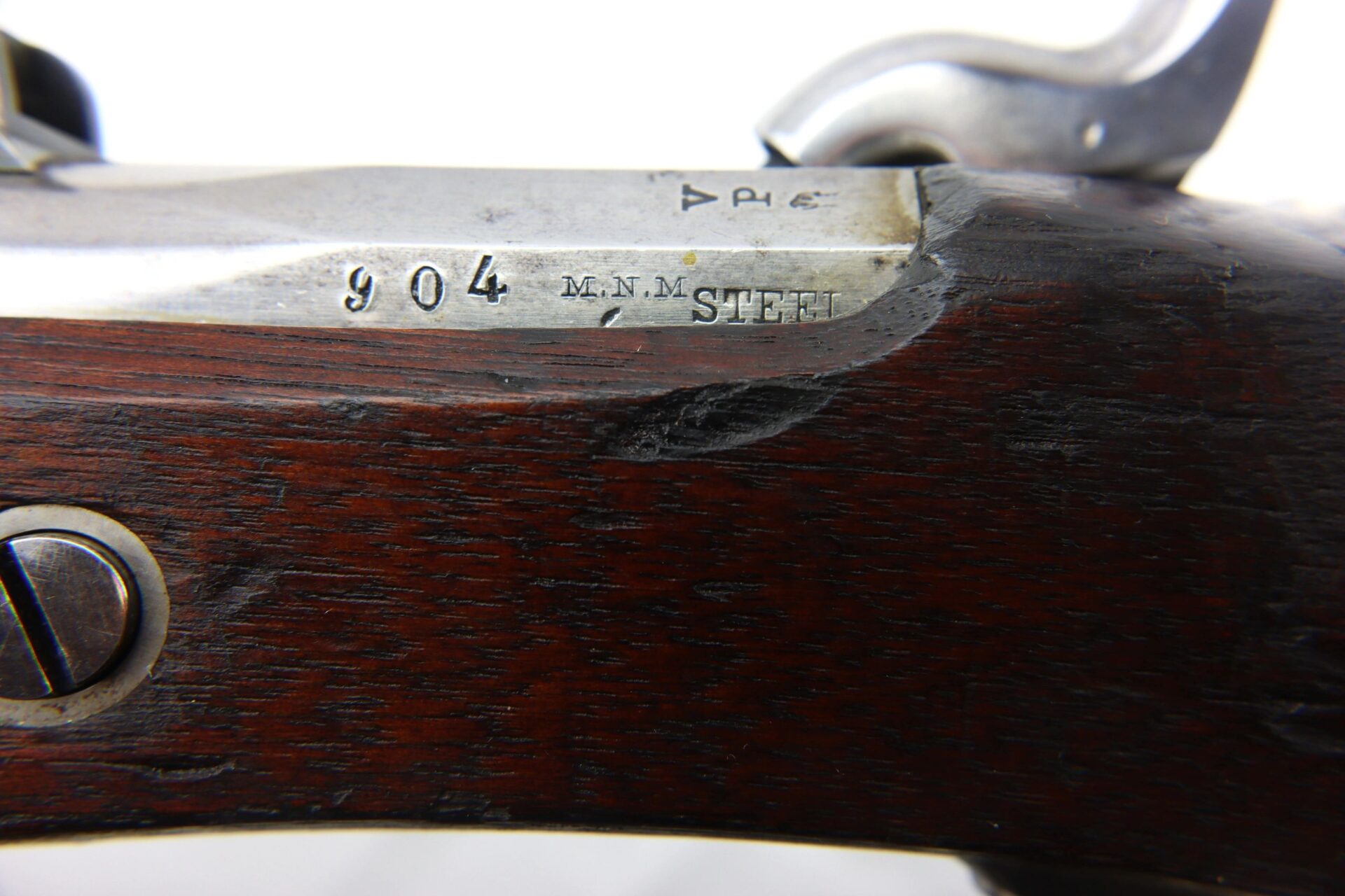 Close-up of a section of the U.S. Model 1861 Special Colt Contract Rifle Musket dated 1864, SLD, showing engraved "904 M.M.M. STEEL" markings on a metal plate set into the wooden stock.
