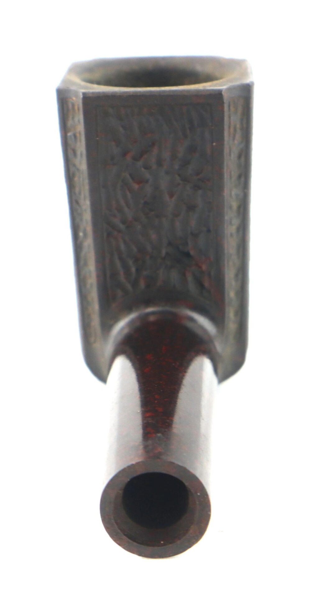 A close-up view of the General George Washington Gutta-Percha Pipe, ca. 1850, featuring a cylindrical bowl and carved decorative designs on the front.