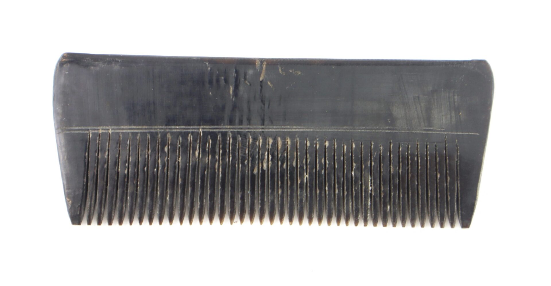A close-up of the "Civil War Comb Constructed of Horn! / SOLD," featuring fine teeth, displayed against a white background.