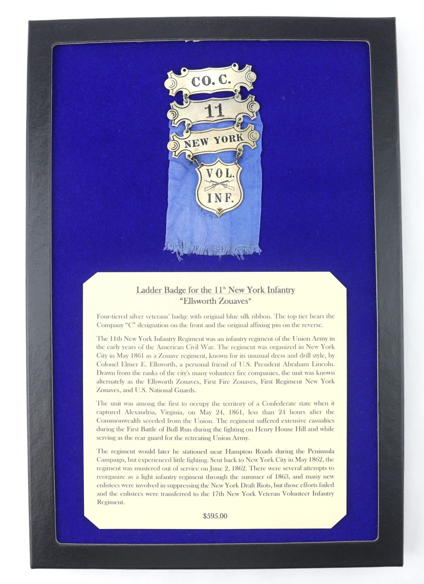 Ladder Badge for the 11th New York Infantry “Ellsworth Zouaves,” displayed on blue velvet with a history plaque, is SOLD.