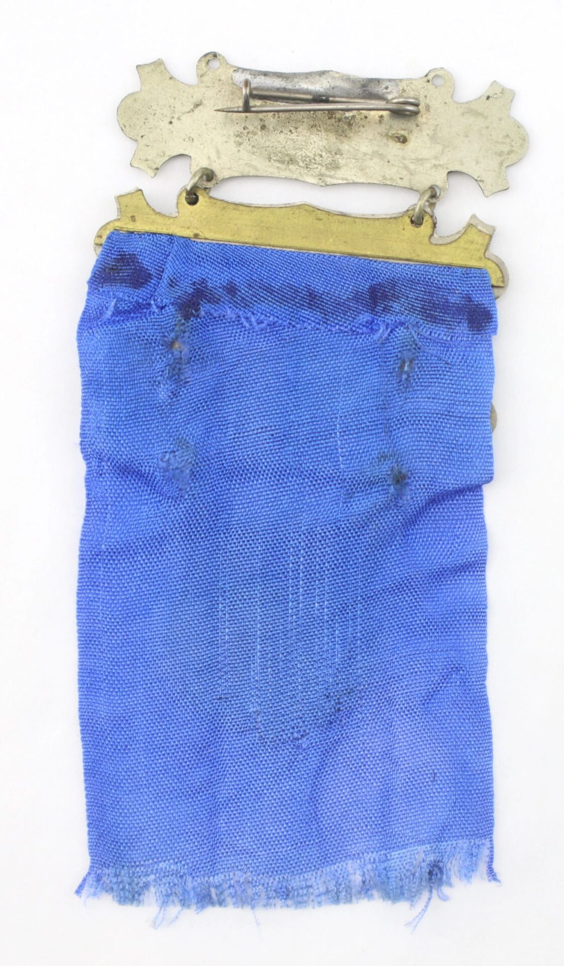 A tarnished metal pin with a plate holds a worn, frayed blue ribbon with visible damage and loose threads. This is the Ladder Badge for the 11th New York Infantry - “Ellsworth Zouaves” / SOLD.