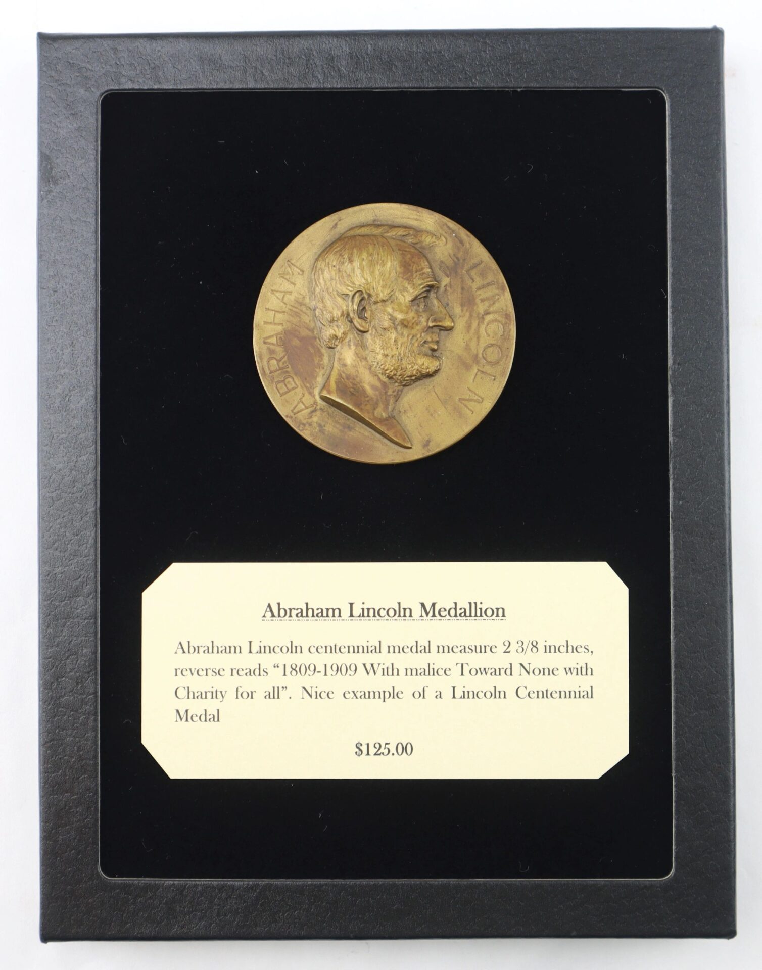 A bronze Abraham Lincoln Medallion, described as a Lincoln Centennial Medal, is mounted on black backing with a label. Product Name: Abraham Lincoln Medallion / SOLD. Price: $125.00.