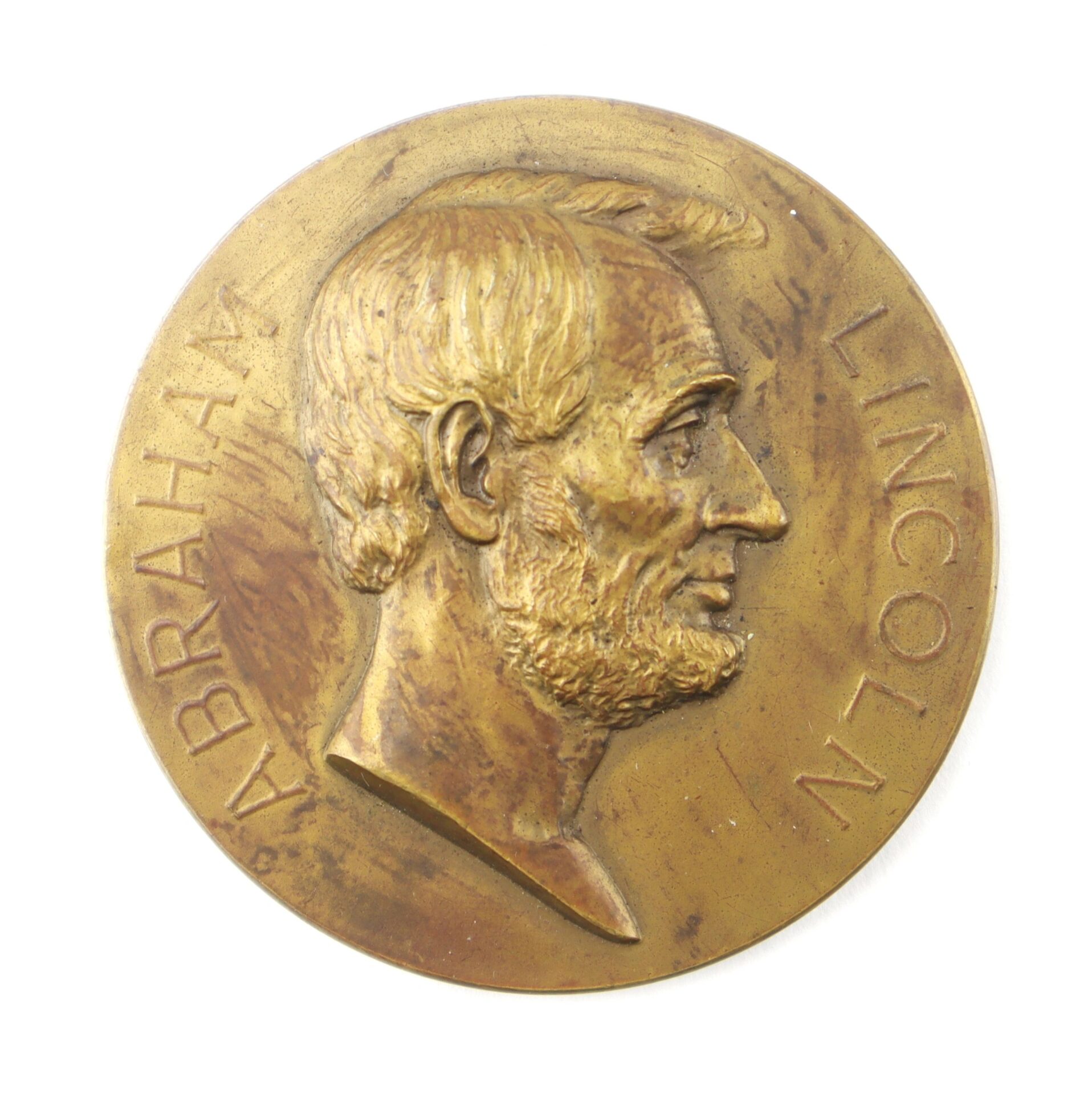 The Abraham Lincoln Medallion features a bronze side profile of Lincoln with his name inscribed along the edge.