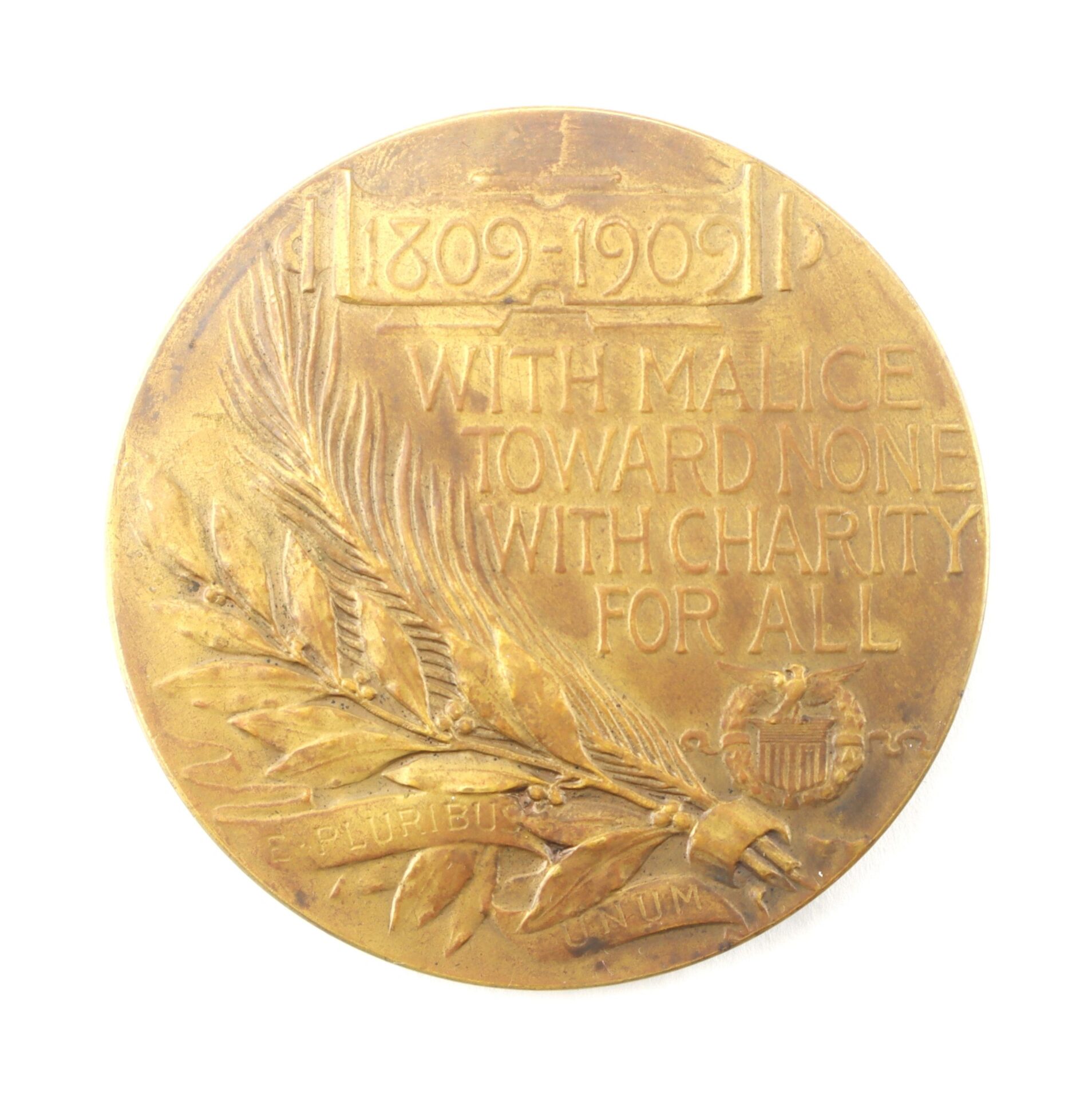 The Abraham Lincoln Medallion (SOLD) features "1809-1909 With malice toward none with charity for all," engraved with a palm branch, laurel leaves, and a small eagle shield.