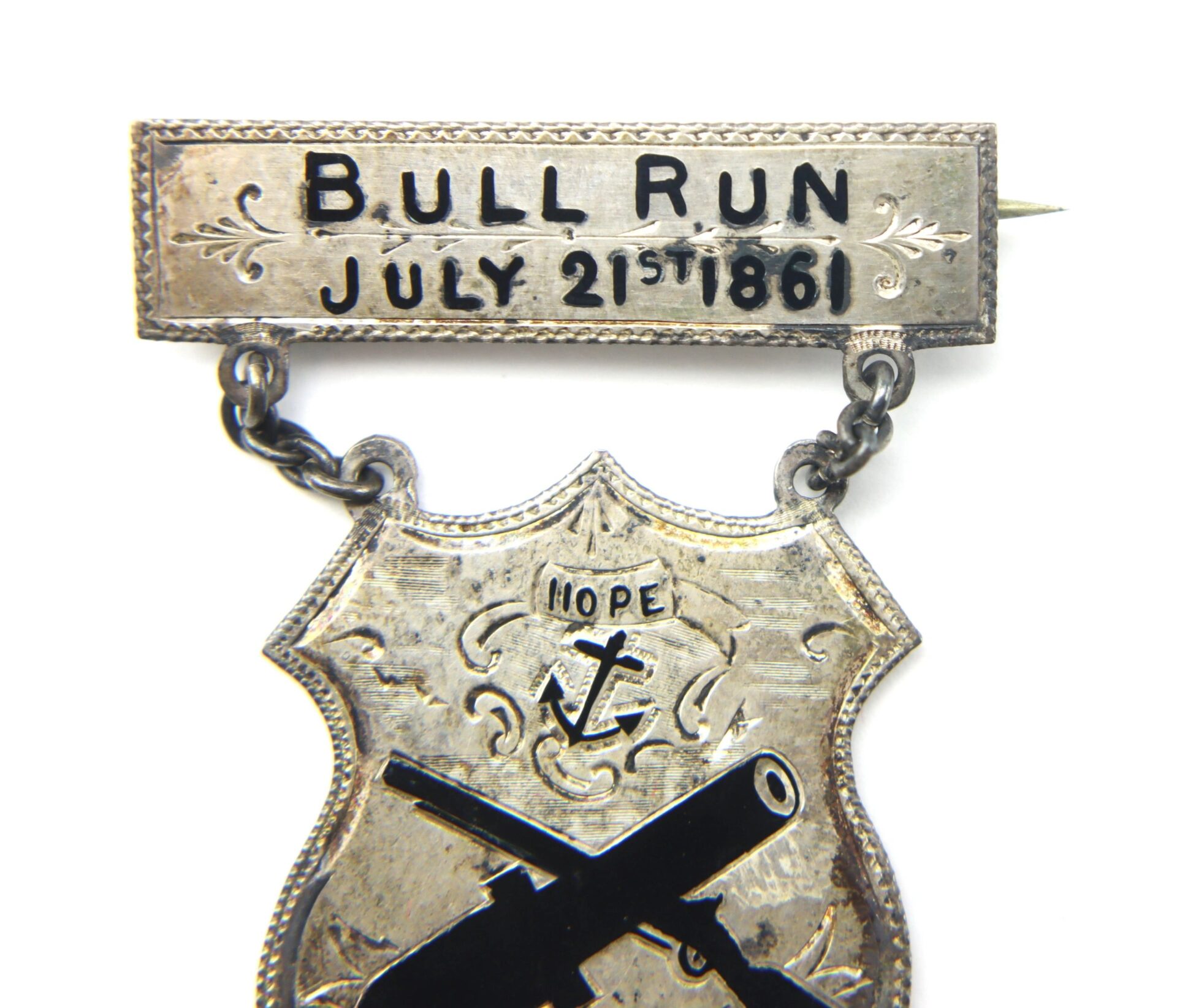 The Rhode Island Regimental Badge "Bull Run July 21 1861" F.R.I.D.M features a silver badge with an engraved plaque, shield with anchor, the word “Hope,” and crossed cannons—honoring the First Rhode Island Detached Militia.