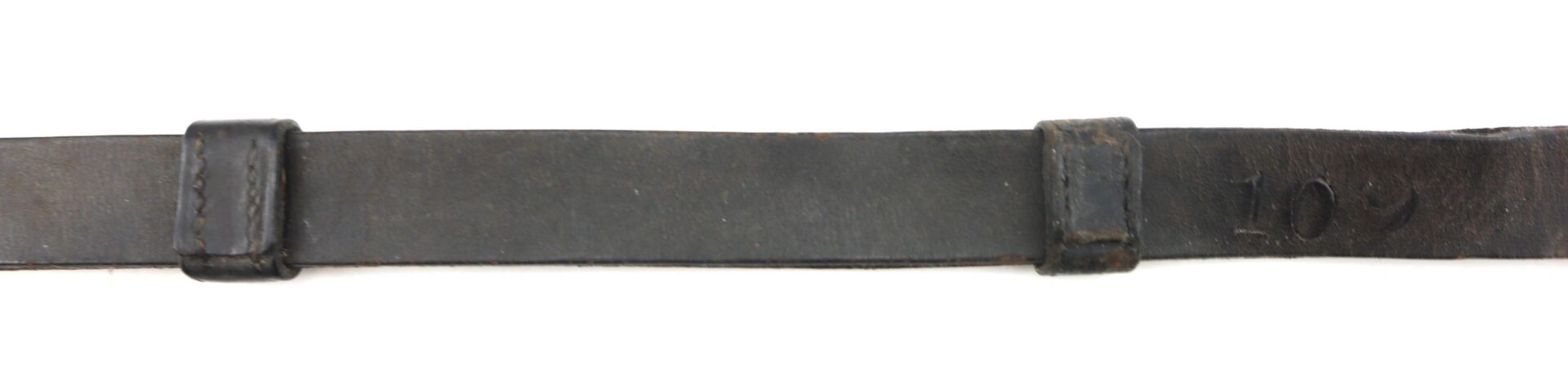 A close-up of the Civil War Saber Knot's worn black leather strap, featuring two rectangular loops and "109" stamped on the right side.