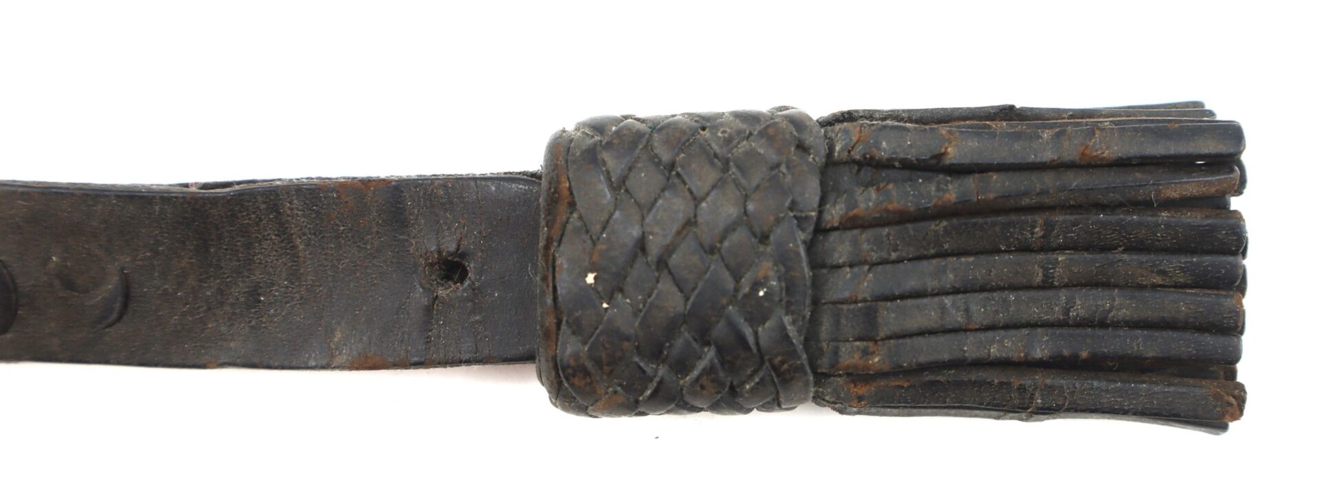 Close-up of a Civil War Saber Knot, featuring a black leather braided handle and multiple flat leather strips at the lash end.