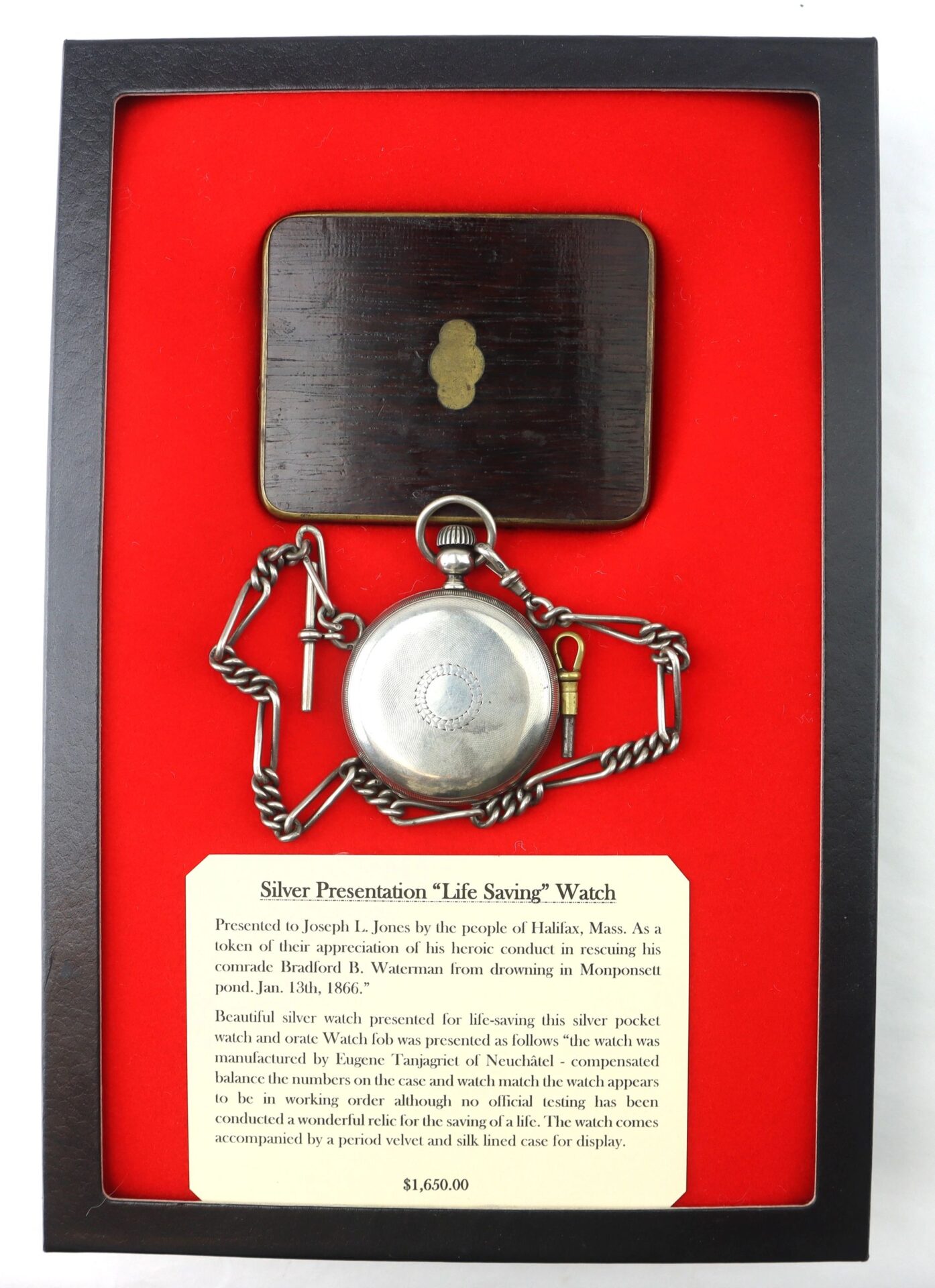 The Silver Presentation “Life Saving” Watch with chain is shown on red fabric beside its wooden case and a plaque noting it was awarded to Joseph L. Jones in 1863.