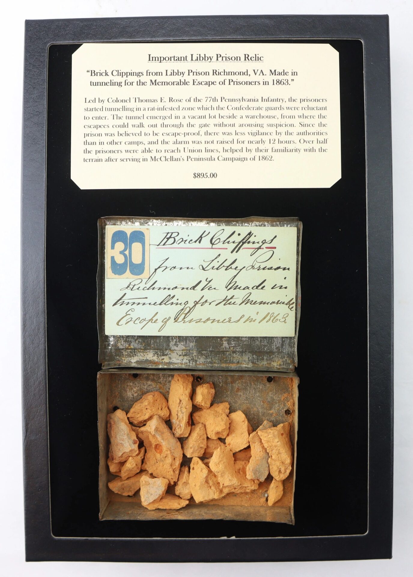 Important Libby Prison Relic / SOLD: Display of “brick clippings” from Libby Prison, Richmond, VA, with a label noting their origin from an 1863 Civil War tunnel escape; originally priced at $895.00.