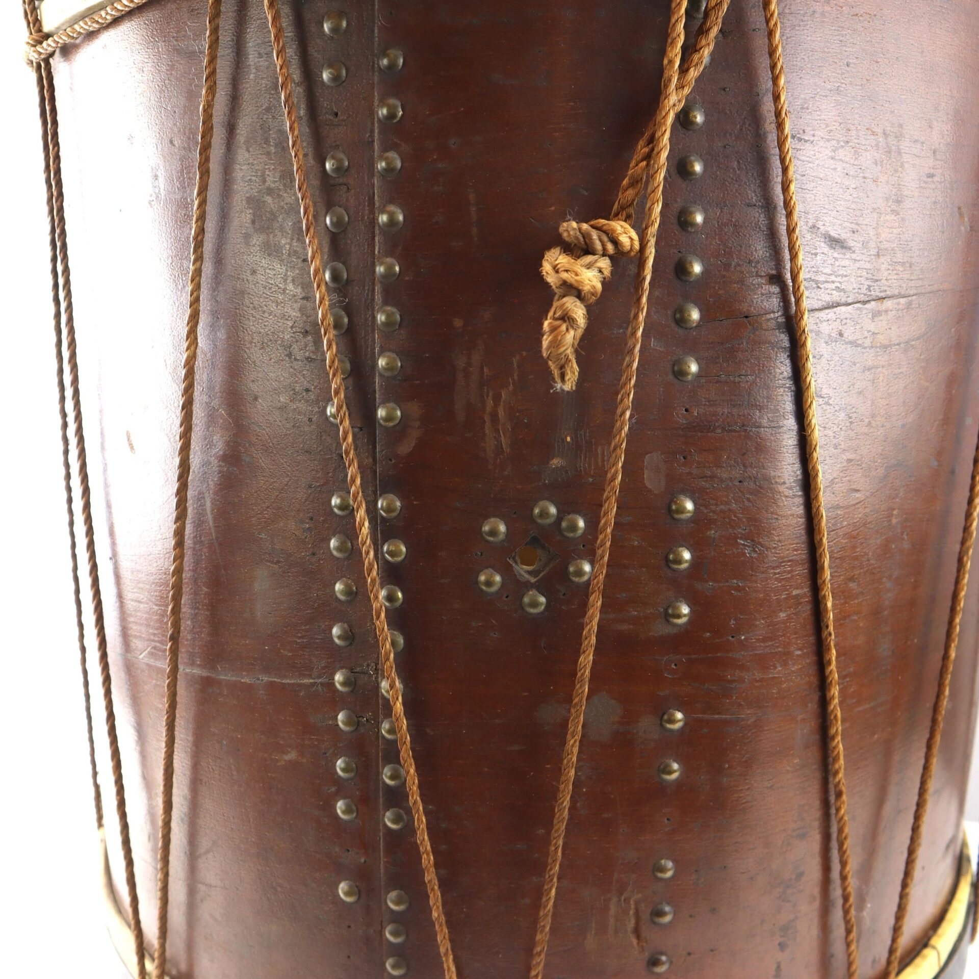 Close-up of the “Galvanized Yankees” Regimental Bass Drum of the 1st U.S. Volunteers, showing its wooden body, metal studs, vertical rope tensioning, and knotted cord.