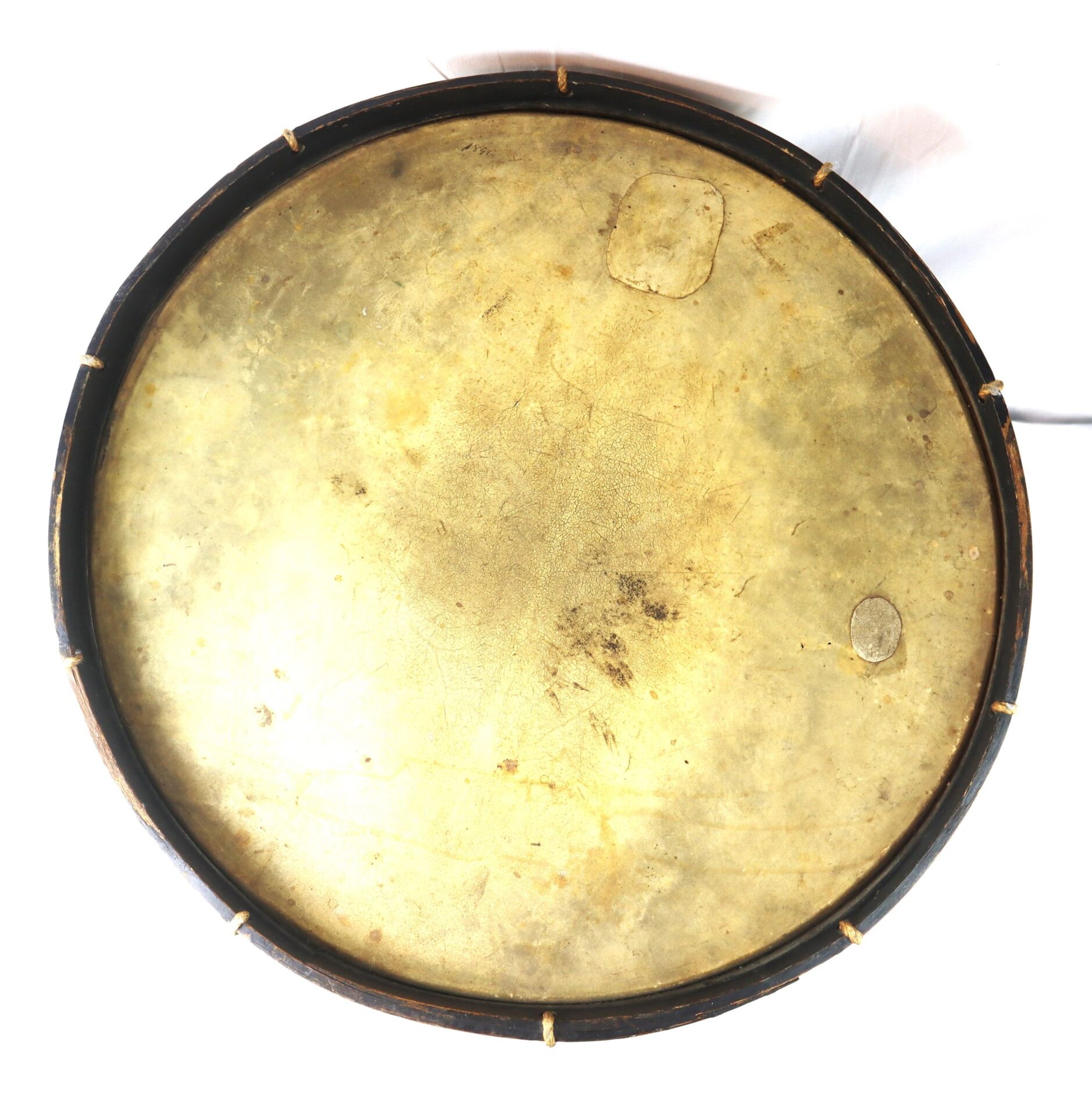 A round, flat “Galvanized Yankees” Regimental Bass Drum of the 1st U.S. Volunteers, featuring a worn light-brown drumhead and dark frame, viewed from above against a white background.