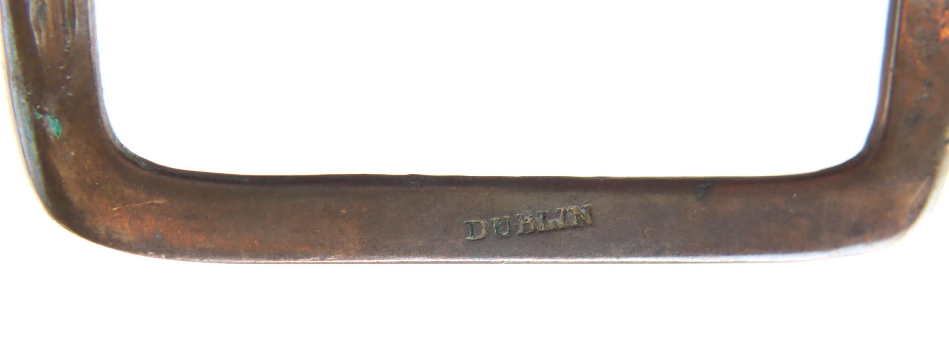 A close-up of a Pair of Colonial Shoe Buckles with the word "DUBLIN" stamped on their metal surface.