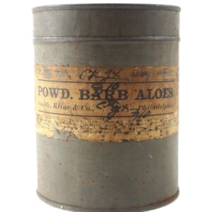 A cylindrical metal Civil War Aloe Container with a worn, yellowed label reading "POWD. BARB ALOES" from Smith, Kline & Co., Philadelphia; the label shows aging and handwritten notes.