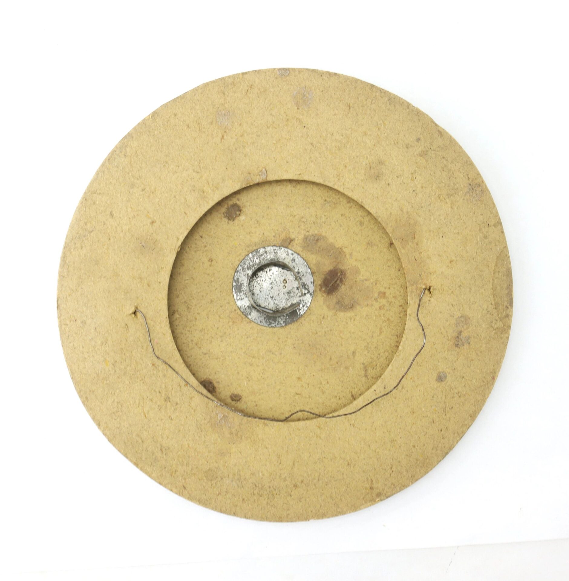 The Political Parade Lantern is a round piece of brown, worn cardboard with a metal fixture and hanging wire on the back, displayed against a white background.