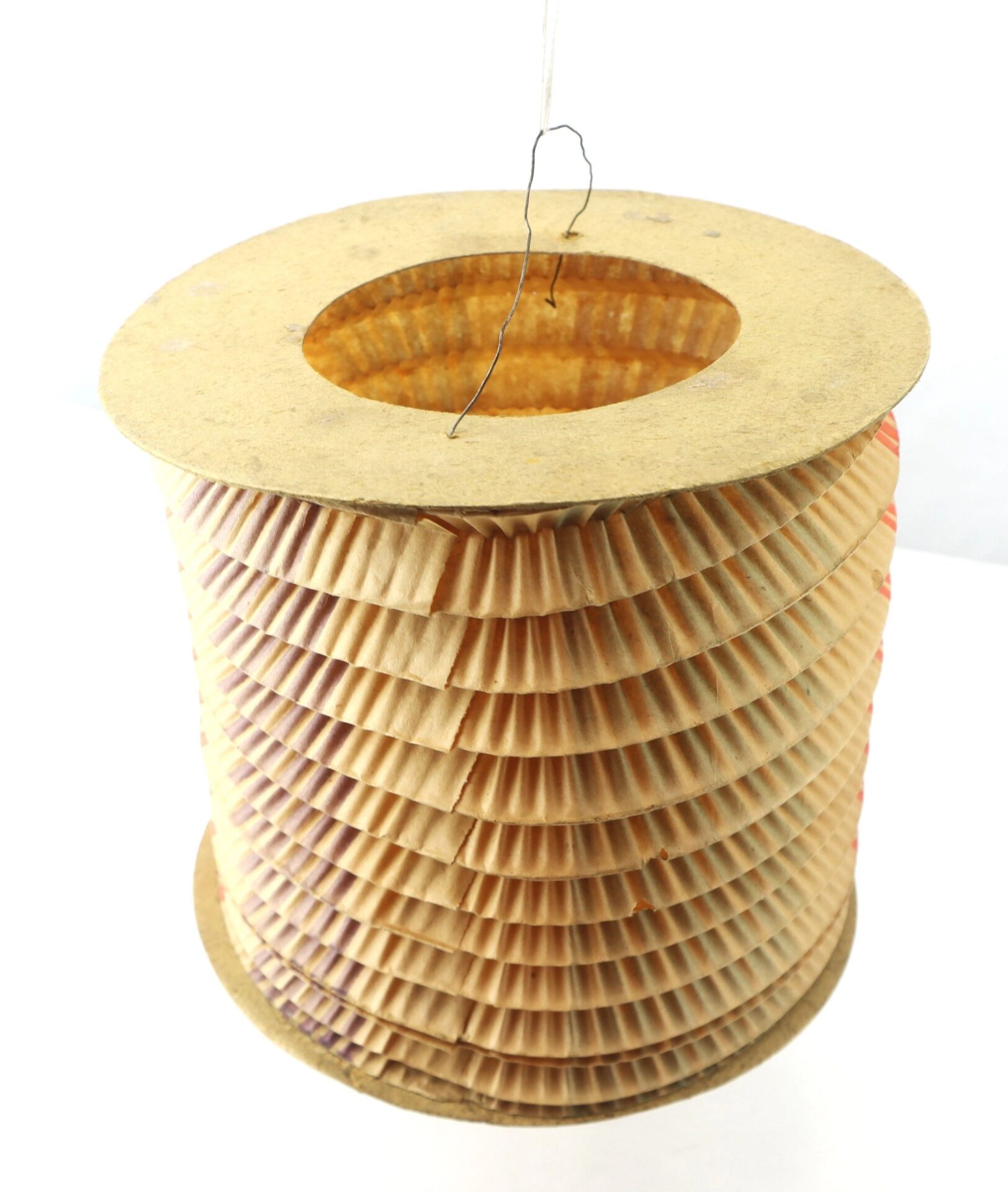 The Political Parade Lantern is a cylindrical paper lantern with a wire handle and accordion-style pleats, shown hanging against a white background.