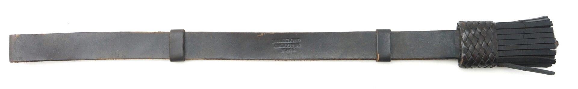 The Enlisted Saber Knot – Near Mint Condition Example features a black leather strap with several wide leather tails attached at one end and a flat handle.