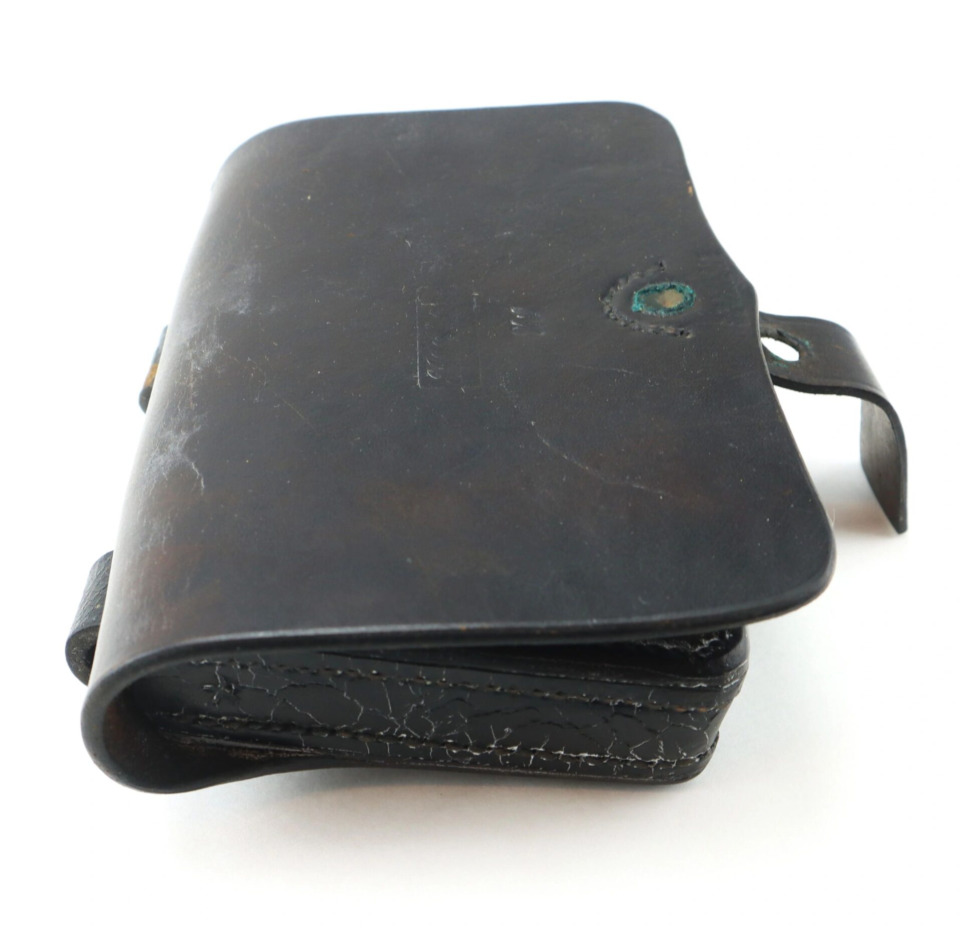 A vintage black leather Pistol Cartridge Box with a flap closure and visible creases, displayed against a plain white background.