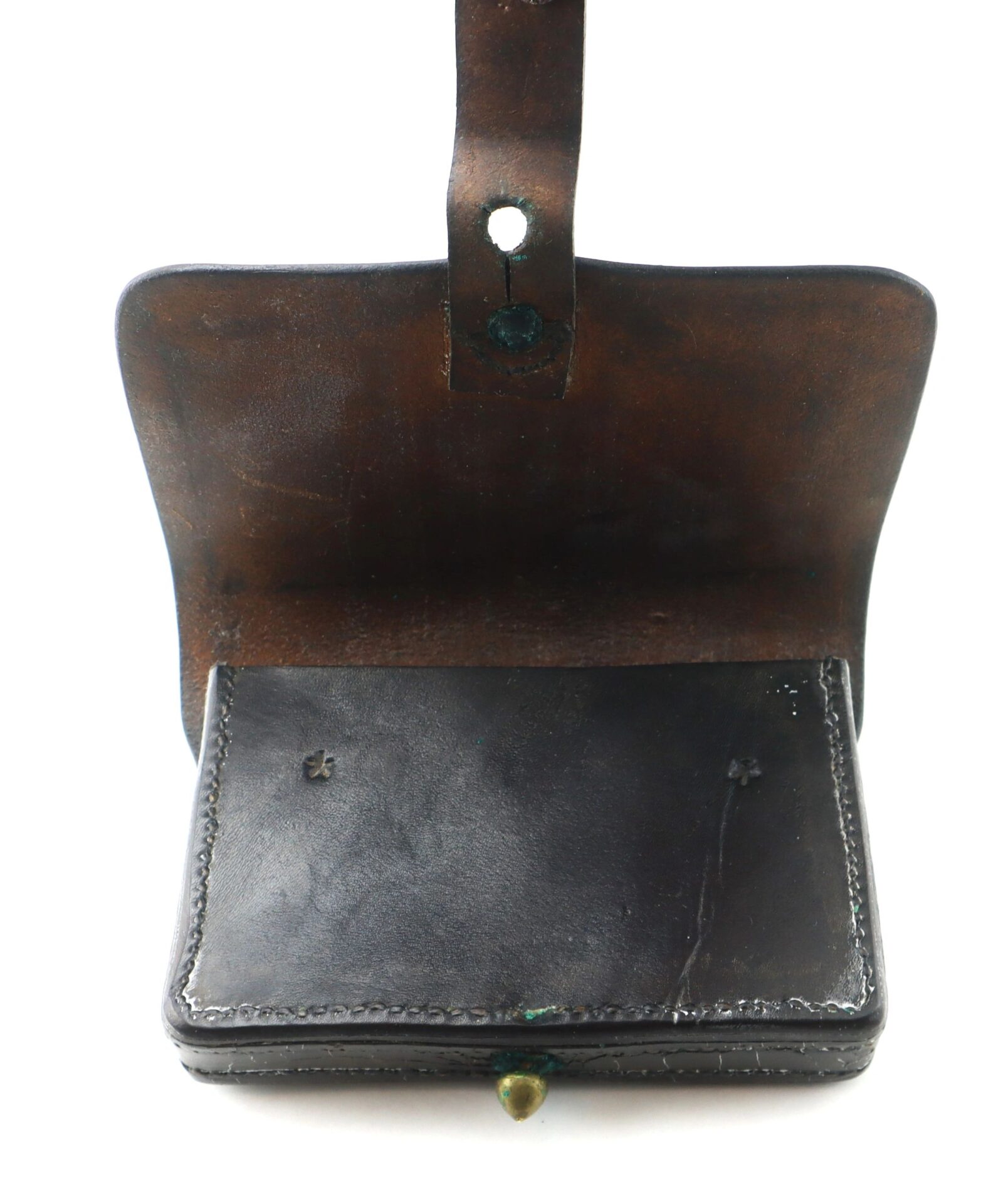 A vintage black leather Pistol Cartridge Box with a flap and button closure, some wear, and a strap featuring a hole at the top. SOLD.